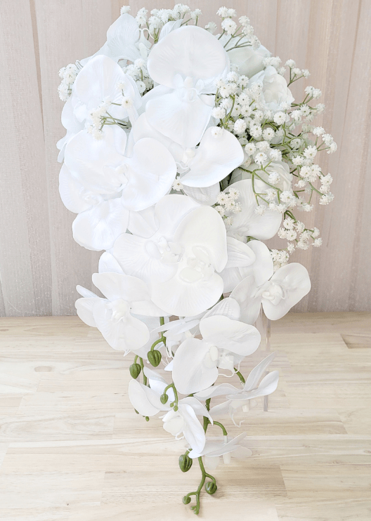 Artificial wedding cascading bridal bouquet with white faux orchids, roses, smaller blooms and green foliage. Made in Melbourne by Flowers For Ever After, shipping Australia and Worldwide.