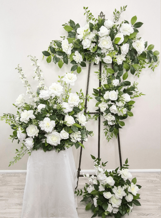 Artificial White & Foliage Arbor Florals; arbour, tieback, arrangement,plinth sign decor and more. Silk roses and foliage. Wedding flower package made in melbourne, by Flowers For Ever After. Shipping Australia wide, custom orders welcome.