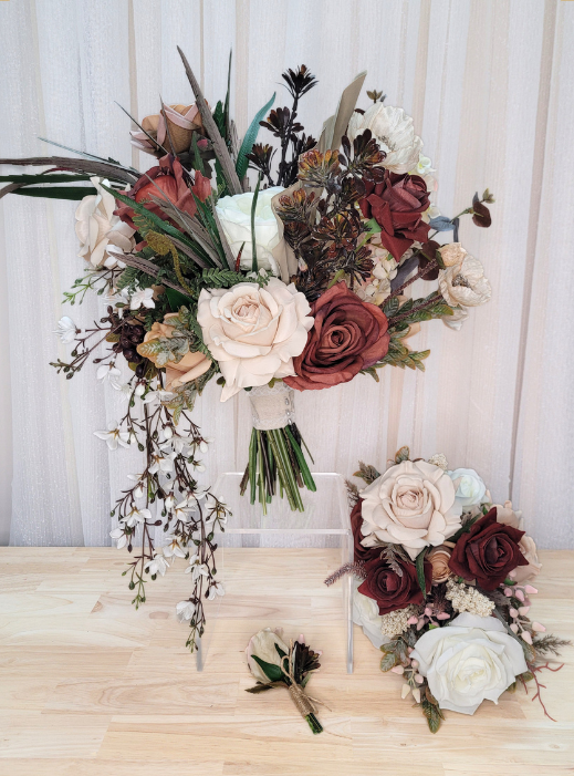 A rustic faux flower bridal bouquet arrangement with blush pink, burgundy, and cream faux flowers. A smaller matching bouquet and a gents boutonniere. Made in Melbourne, shipping worldwide, custom orders available.