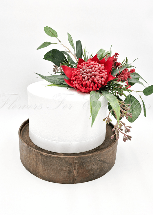 Artificial wedding cake flower pieces with pink faux waratah, small blooms and green native-style foliage. For birthday, event and celebration cakes. Made in Melbourne by Flowers For Ever After, shipping Australia and Worldwide.