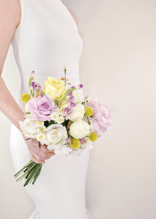 Artificial wedding bridesmaid bouquet, handheld side view of lilac faux roses, white peonies, yellow roses and small daisies. Made in Melbourne by Flowers For Ever After, shipping Australia and Worldwide.