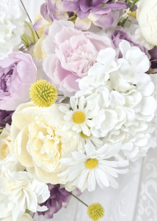 Artificial wedding arbor floral close-up with a pale pink faux peony, cream and lilac roses, white hydrangea, daisies and yellow pompom flowers. Made in Melbourne by Flowers For Ever After, shipping Australia and Worldwide.