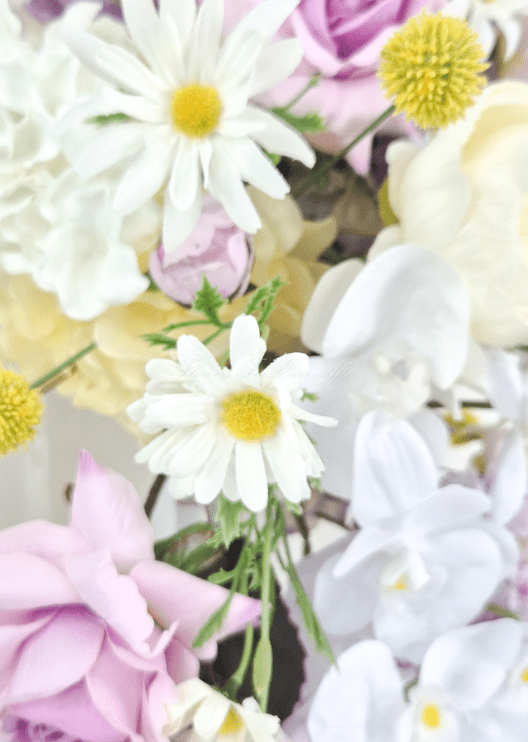 Artificial wedding arbor flower detail showing white faux daisies with yellow centres, white orchids, lilac rose petals and yellow pompom flowers. Made in Melbourne by Flowers For Ever After, shipping Australia and Worldwide.