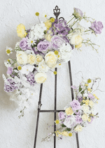 Artificial wedding arbor floral set on an easel with lilac and cream faux roses, white hydrangea, orchids, daisies and yellow pompom flowers. Made in Melbourne by Flowers For Ever After, shipping Australia and Worldwide.