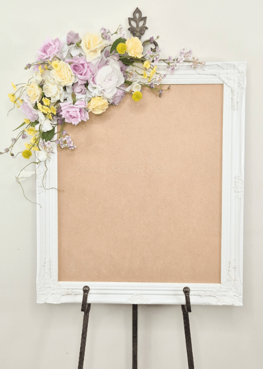 Artificial wedding sign floral spray with lilac, cream and yellow faux roses, white blooms, yellow pompom flowers and trailing branches. Made in Melbourne by Flowers For Ever After, shipping Australia and Worldwide.