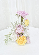 Artificial wedding small table arrangement with a raised lilac faux rose, yellow and white roses and fine white sprigs. Made in Melbourne by Flowers For Ever After, shipping Australia and Worldwide.