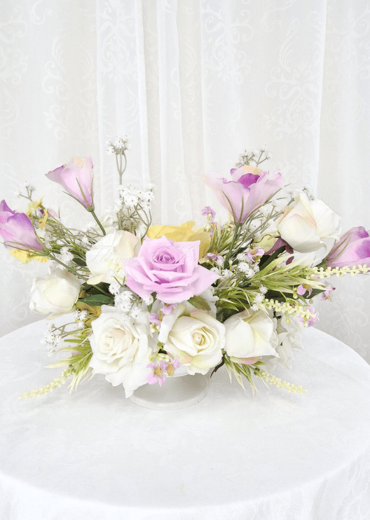 Artificial wedding table centrepiece, reverse view of lilac and white faux roses, yellow blooms and fine pale sprigs. Made in Melbourne by Flowers For Ever After, shipping Australia and Worldwide.
