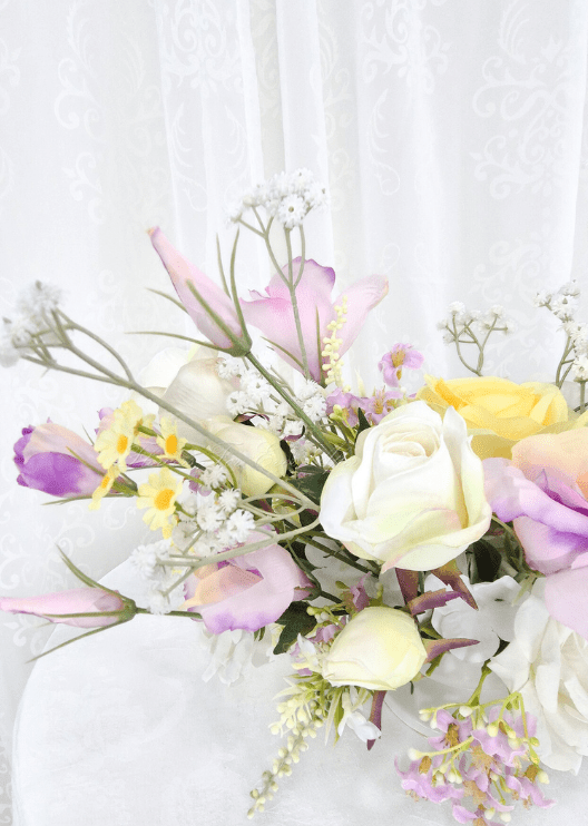 Artificial wedding table flower detail showing white and lilac faux rosebuds, yellow rose petals and tiny white sprigs. Made in Melbourne by Flowers For Ever After, shipping Australia and Worldwide.