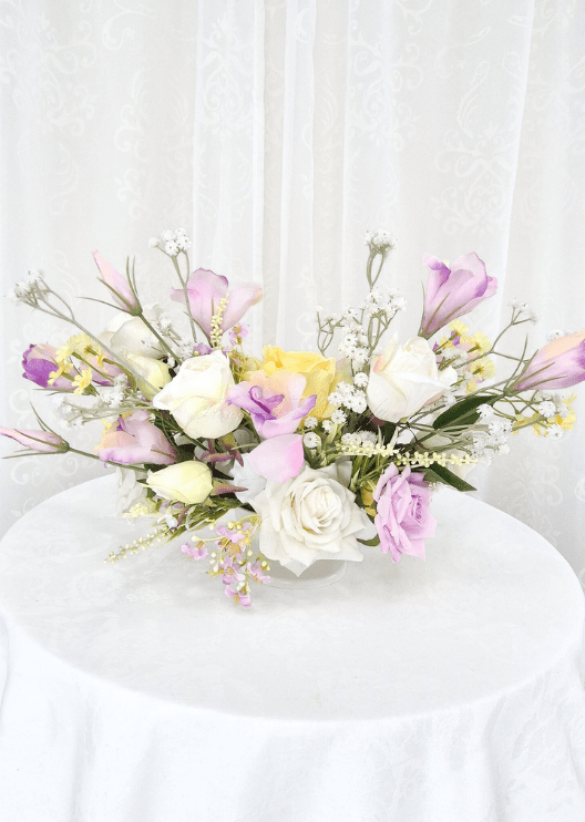 Artificial wedding table centrepiece with white, lilac and yellow faux roses, small lilac blossoms and fine white sprigs. Made in Melbourne by Flowers For Ever After, shipping Australia and Worldwide.