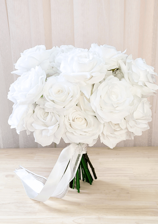 Artificial wedding bridal bouquet with white faux roses and peonies, wrapped green stems and trailing ivory ribbon. Made in Melbourne by Flowers For Ever After, shipping Australia and Worldwide.
