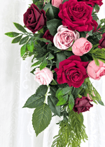 Artificial wedding arbor floral detail showing red, burgundy and pink faux roses, green leaves and fern-like foliage. Made in Melbourne by Flowers For Ever After, shipping Australia and Worldwide.