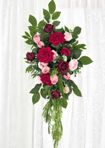 Artificial wedding hanging arbor arrangement with red, burgundy and pink faux roses, broad green leaves and long fern-like foliage. Made in Melbourne by Flowers For Ever After, shipping Australia and Worldwide.