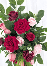 Artificial wedding arbor flower close-up with red, burgundy and pink faux roses, small white sprigs and broad green leaves. Made in Melbourne by Flowers For Ever After, shipping Australia and Worldwide.