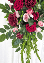 Artificial wedding arbor arrangement close-up with red, burgundy and pink faux roses, broad green leaves and long green floral strands. Made in Melbourne by Flowers For Ever After, shipping Australia and Worldwide.
