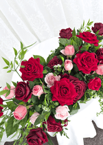 Artificial wedding table arrangement, overhead view of red, burgundy and pink faux roses with layered green foliage. Made in Melbourne by Flowers For Ever After, shipping Australia and Worldwide.