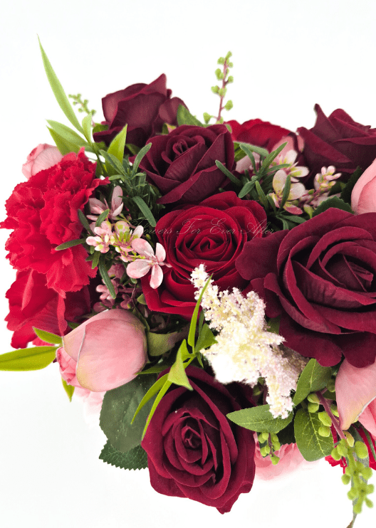 Artificial wedding bouquet detail showing burgundy and red faux roses, pink rosebuds, red carnation, pale plume-like sprig and tiny pink blossoms. Made in Melbourne by Flowers For Ever After, shipping Australia and Worldwide.