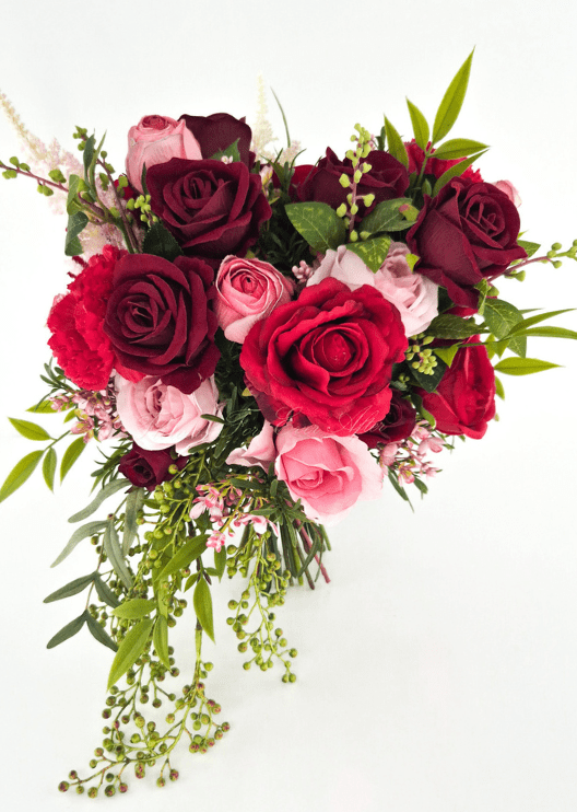 Artificial wedding cascading bridal bouquet, front view of red, burgundy and pink faux roses with long green berry sprigs. Made in Melbourne by Flowers For Ever After, shipping Australia and Worldwide.