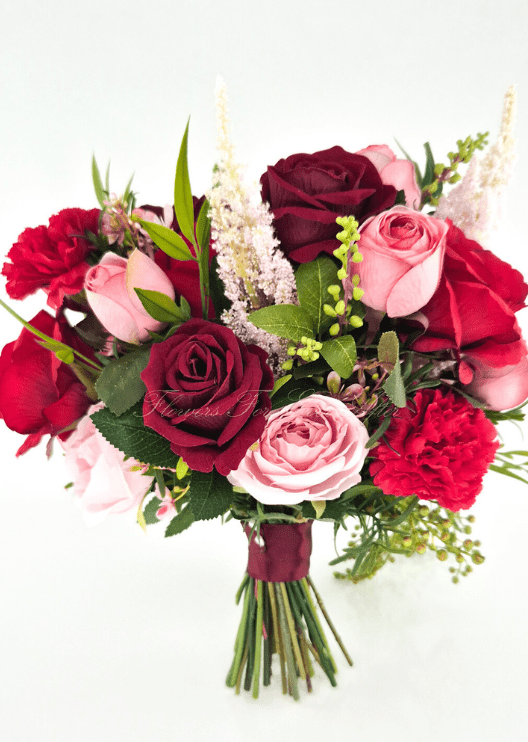 Artificial wedding bridal bouquet, reverse view of burgundy and pink faux roses, red carnations, pale plume-like flowers and burgundy-wrapped stems. Made in Melbourne by Flowers For Ever After, shipping Australia and Worldwide.