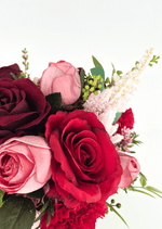 Artificial wedding bouquet close-up with a red faux rose, pink rosebuds, burgundy rose and pale plume-like flowers. Made in Melbourne by Flowers For Ever After, shipping Australia and Worldwide.