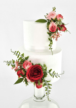 Artificial wedding cake decoration with red and pink faux roses, small pink flowers and green sprigs in upper and lower clusters. For birthday, event and celebration cakes. Made in Melbourne by Flowers For Ever After, shipping Australia and Worldwide.