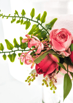 Artificial wedding cake flower detail showing pink and red faux rosebuds, small pink blossoms and green sprigs. For birthday, event and celebration cakes. Made in Melbourne by Flowers For Ever After, shipping Australia and Worldwide.