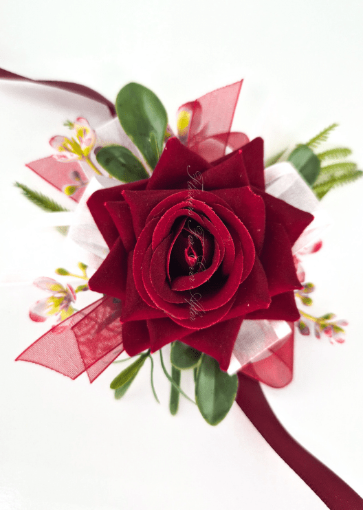 Artificial wedding wrist corsage, overhead view of a burgundy faux rose, tiny pink blossoms and burgundy and white ribbons. For formals, proms and ball occasions. Made in Melbourne by Flowers For Ever After, shipping Australia and Worldwide.