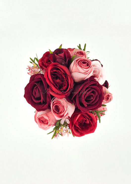 Artificial wedding small bouquet, overhead view of red, burgundy and pink faux roses with tiny pink blossoms. Made in Melbourne by Flowers For Ever After, shipping Australia and Worldwide.