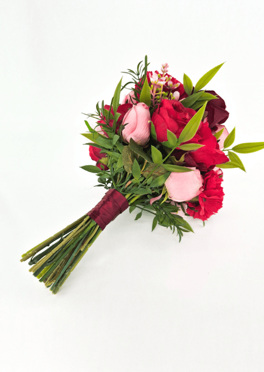 Artificial wedding small bouquet, reverse side view showing red and pink faux roses, green leaves and burgundy-wrapped stems. Made in Melbourne by Flowers For Ever After, shipping Australia and Worldwide.
