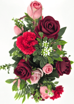 Artificial wedding table arrangement, overhead view of pink and burgundy faux roses, red carnations, white flower sprigs and green leaves. Made in Melbourne by Flowers For Ever After, shipping Australia and Worldwide.