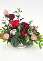 Artificial wedding low table arrangement with pink and burgundy faux roses, red carnations, small white sprigs and spreading green foliage. Made in Melbourne by Flowers For Ever After, shipping Australia and Worldwide.