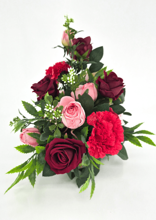 Artificial wedding table arrangement, end view of pink and burgundy faux roses, red carnations, white sprigs and green foliage. Made in Melbourne by Flowers For Ever After, shipping Australia and Worldwide.
