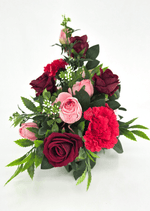 Artificial wedding table arrangement, end view of pink and burgundy faux roses, red carnations, white sprigs and green foliage. Made in Melbourne by Flowers For Ever After, shipping Australia and Worldwide.
