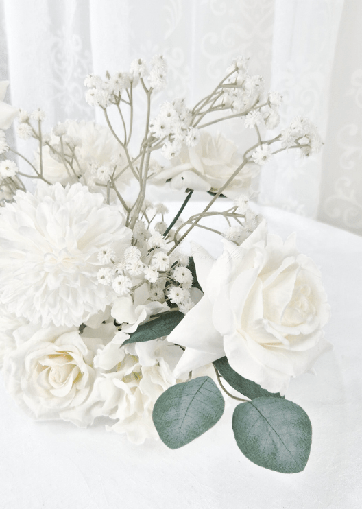 Artificial wedding table flower close-up with a white faux rose, white pompom bloom, tiny white sprigs and eucalyptus. Made in Melbourne by Flowers For Ever After, shipping Australia and Worldwide.