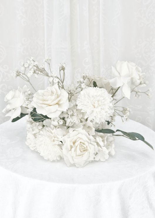 Artificial wedding table centrepiece, front view of white faux roses, white pompom blooms, tiny white flowers and eucalyptus. Made in Melbourne by Flowers For Ever After, shipping Australia and Worldwide.