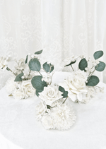 Artificial wedding group of small table arrangements with white faux roses, white pompom blooms and eucalyptus leaves. Made in Melbourne by Flowers For Ever After, shipping Australia and Worldwide.