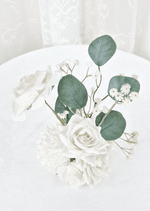 Artificial wedding small table arrangement, overhead view of white faux roses, tiny white flowers and rounded eucalyptus leaves. Made in Melbourne by Flowers For Ever After, shipping Australia and Worldwide.