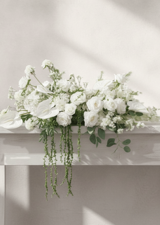 Artificial wedding long table garland with white faux roses, clustered white flowers and trailing green foliage. Made in Melbourne by Flowers For Ever After, shipping Australia and Worldwide.