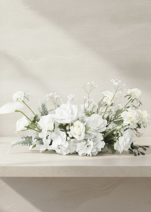 Artificial wedding low table arrangement with white faux roses, orchids, hydrangea, fine white flowers and green foliage. Made in Melbourne by Flowers For Ever After, shipping Australia and Worldwide.