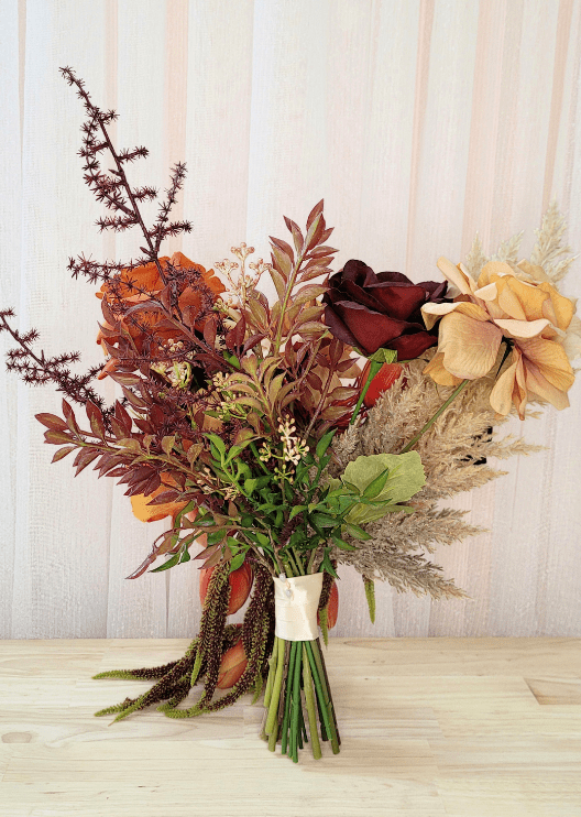 Artificial wedding bouquet, reverse view of orange and burgundy faux roses, beige blooms, pale plumes and burgundy foliage. Made in Melbourne by Flowers For Ever After, shipping Australia and Worldwide.