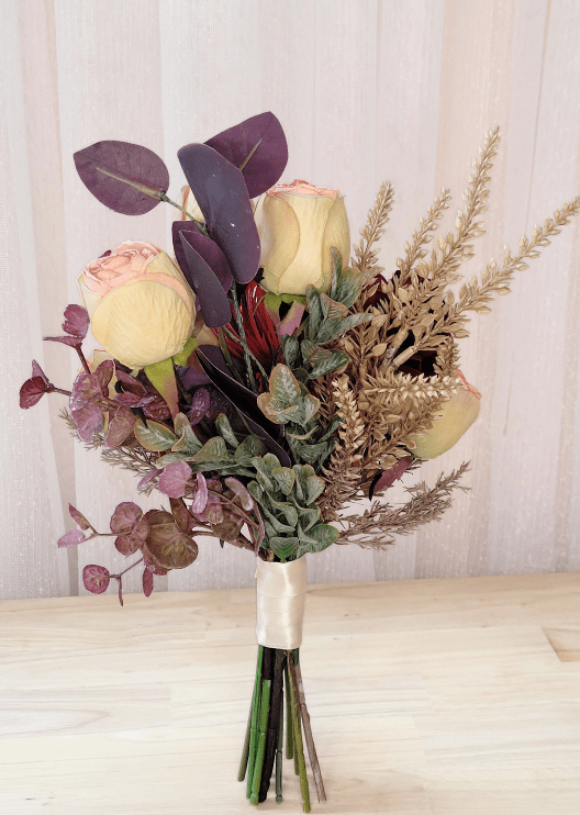 Artificial wedding small bouquet, reverse view of cream-pink faux rosebuds, dark eucalyptus and fine tan sprigs. Made in Melbourne by Flowers For Ever After, shipping Australia and Worldwide.