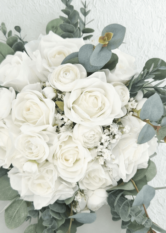 Artificial wedding bridal bouquet, front view of ivory and white faux roses, small white flowers and blue-grey eucalyptus leaves. Made in Melbourne by Flowers For Ever After, shipping Australia and Worldwide.