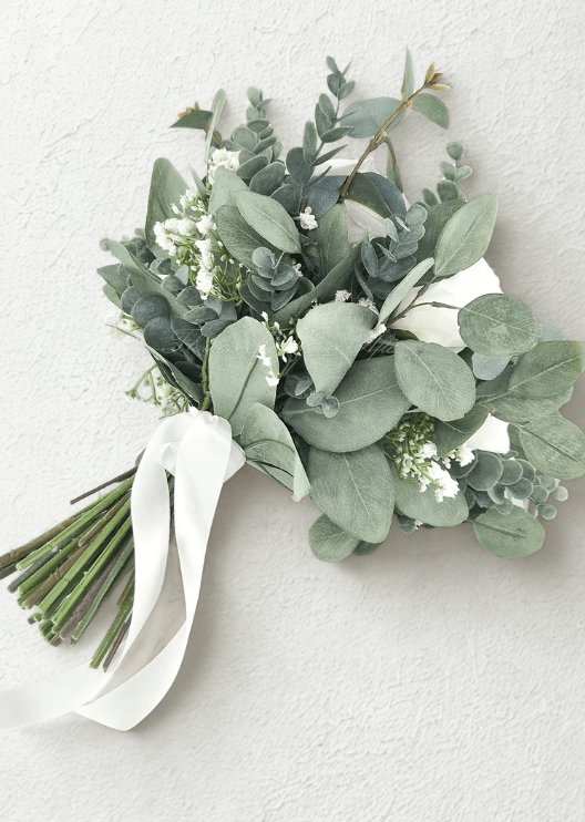 Artificial wedding bridal bouquet, angled view of ivory and white faux roses surrounded by blue-grey eucalyptus leaves. Made in Melbourne by Flowers For Ever After, shipping Australia and Worldwide.