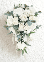 Artificial wedding teardrop bridal bouquet with white faux roses, clustered white blooms, fine white filler flowers, eucalyptus and trailing pale strands. Made in Melbourne by Flowers For Ever After, shipping Australia and Worldwide.