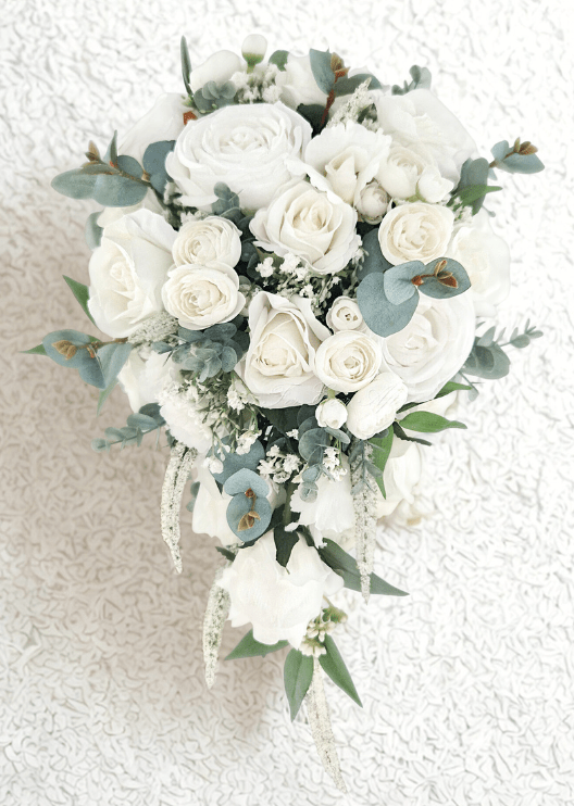 Artificial wedding teardrop bridal bouquet with white faux roses, clustered white blooms, fine white filler flowers, eucalyptus and trailing pale strands. Made in Melbourne by Flowers For Ever After, shipping Australia and Worldwide.