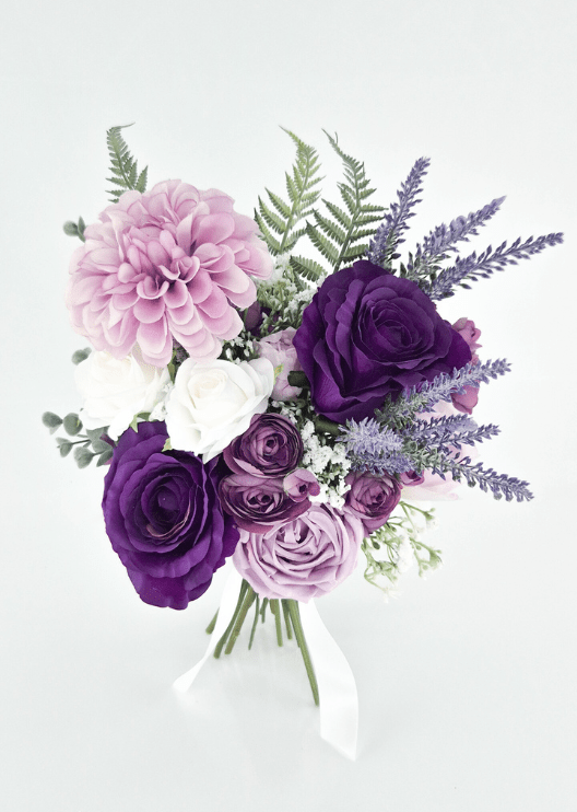 Artificial wedding bridesmaid bouquet, overhead view of purple and lilac faux roses, pink dahlia, white blooms and lavender-like sprigs. Made in Melbourne by Flowers For Ever After, shipping Australia and Worldwide.