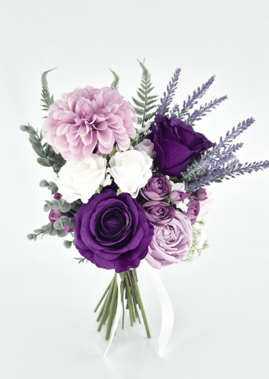 Artificial wedding bridesmaid bouquet, angled view of purple and lilac faux roses, pink dahlia, white blooms and lavender-like sprigs. Made in Melbourne by Flowers For Ever After, shipping Australia and Worldwide.