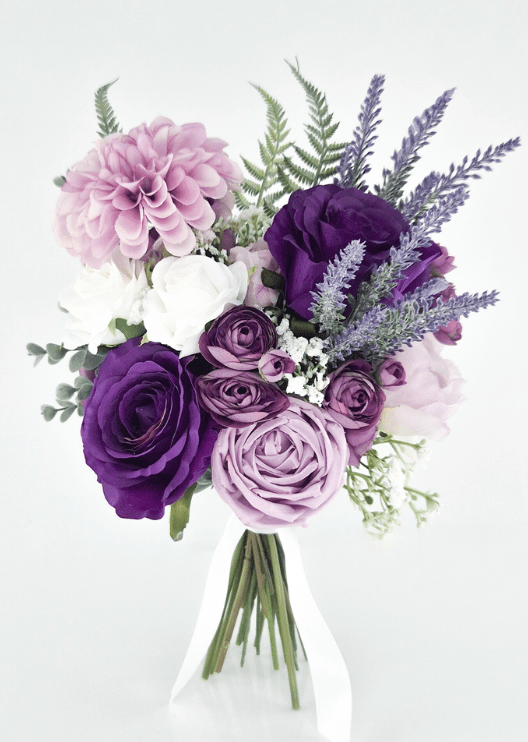 Artificial wedding bridesmaid bouquet with purple and lilac faux roses, pink dahlias, white blooms, lavender-like sprigs and green fern-like leaves. Made in Melbourne by Flowers For Ever After, shipping Australia and Worldwide.