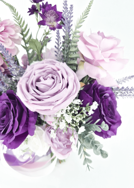 Artificial wedding bouquet close-up with lilac and purple faux roses, tiny white flowers, lavender-like sprigs and rounded green leaves. Made in Melbourne by Flowers For Ever After, shipping Australia and Worldwide.