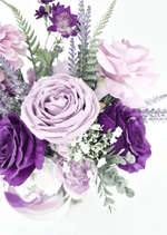Artificial wedding bouquet close-up with lilac and purple faux roses, tiny white flowers, lavender-like sprigs and rounded green leaves. Made in Melbourne by Flowers For Ever After, shipping Australia and Worldwide.