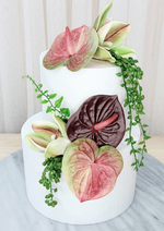 Artificial wedding cake decoration, front view of pink-green and burgundy faux anthuriums, green orchids and trailing greenery. For birthday, event and celebration cakes. Made in Melbourne by Flowers For Ever After, shipping Australia and Worldwide.